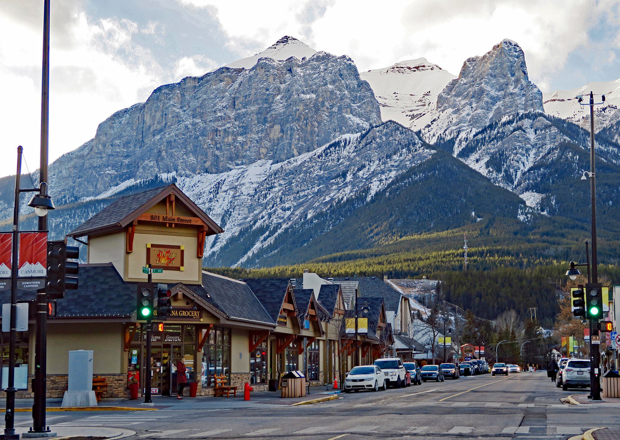 A scenic view of a mountain town street in Alberta, Canada, featuring the Rocky Mountains, symbolizing the active lifestyle for those looking to buy steroids online in Alberta.